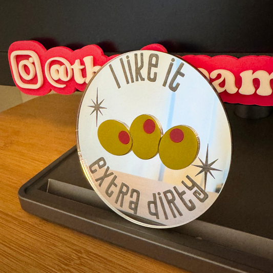 standing photo of mirror coaster with etched words and inlaid green olives with red pimento