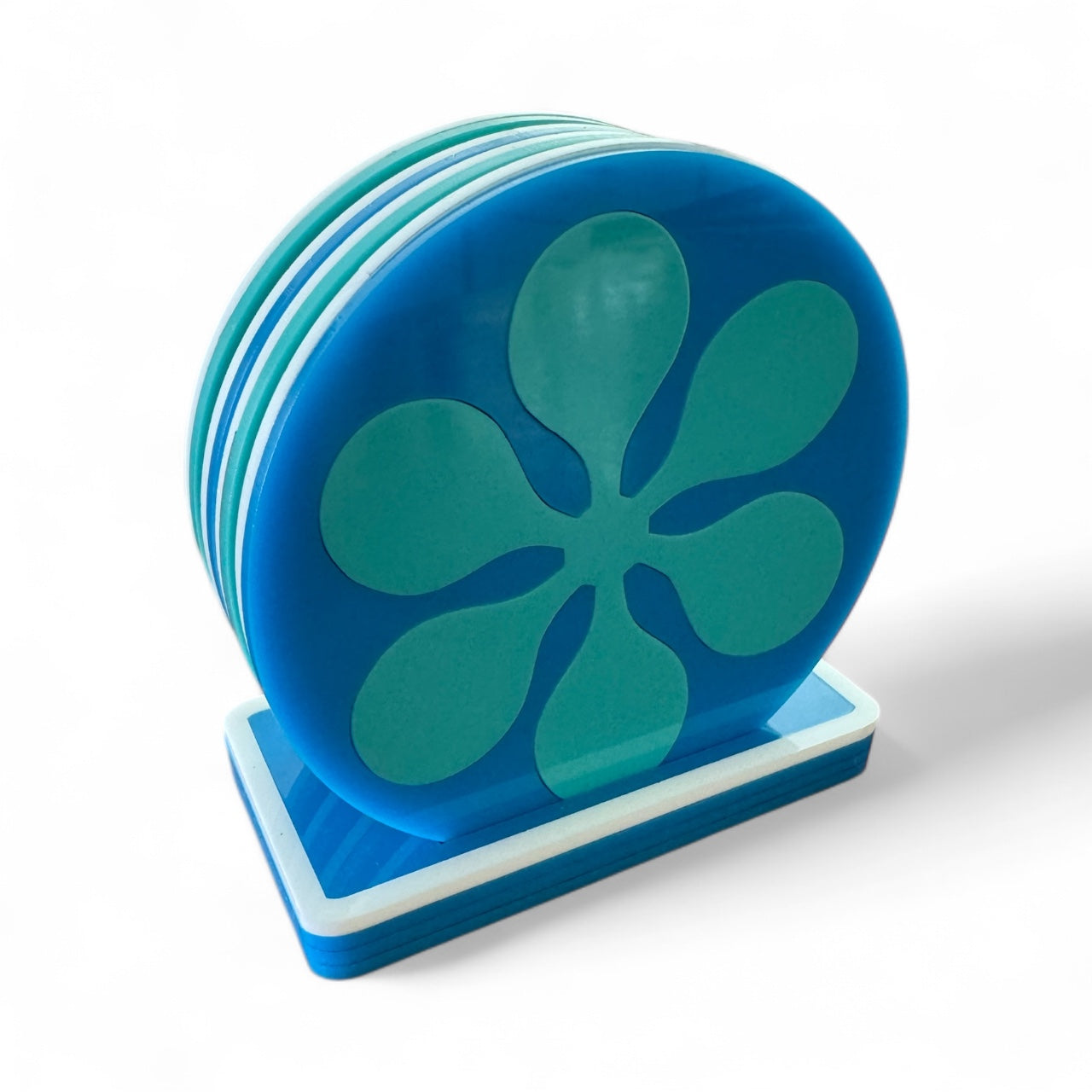 Set of blue coasters with a retro flower design on a white background