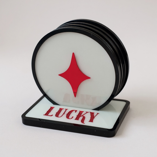 Set of coasters with a red star design and 'LUCKY' text on a white background