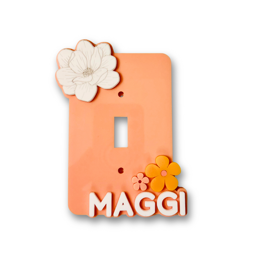 Decorative acrylic wall plate with a magnolia flower and name text on a white background
