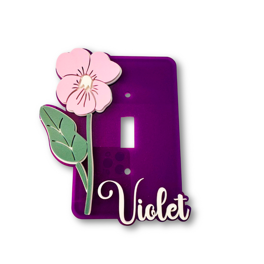 Purple switch plate with pink flower and green leaves on a white background